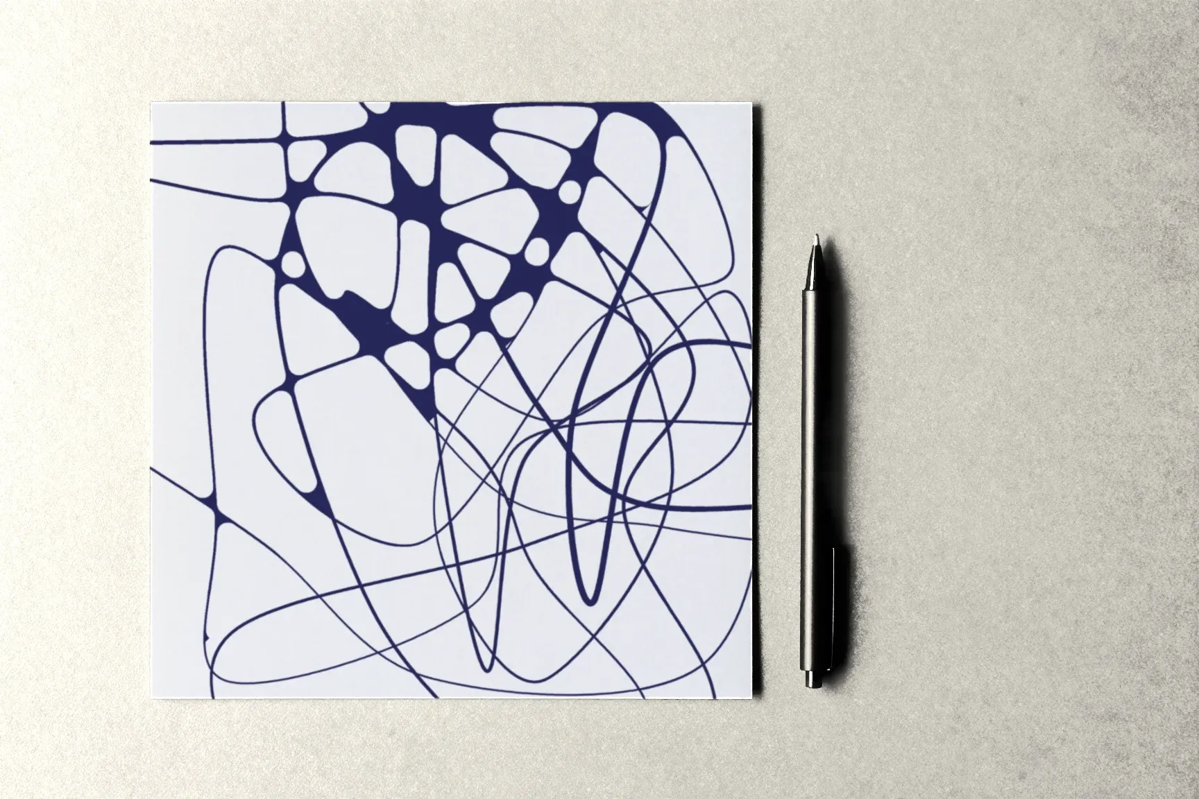 A sheet rounded in one corner only, the other intersections still sharp; a pen beside it.
