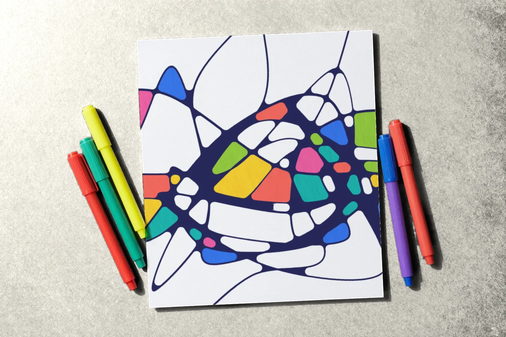 A drawing two thirds coloured, bright markers spread out beside it.