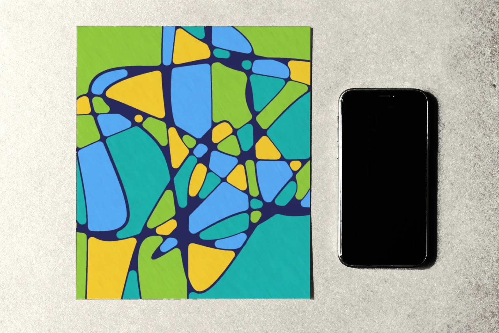 A drawing and a smartphone side by side on the table.