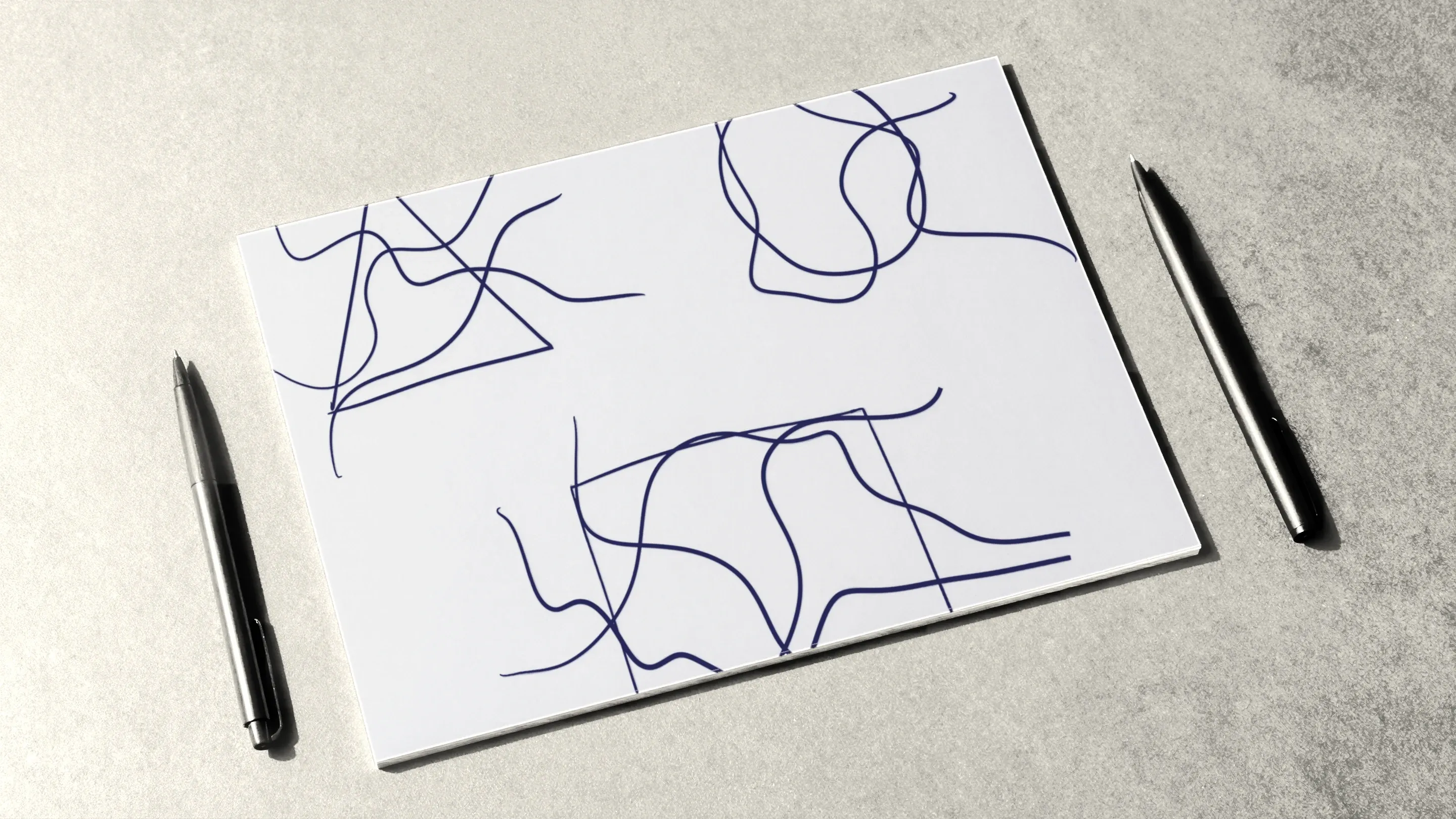A triangle, a circle and a square crossed by flowing lines, on a sheet lying between two pens.